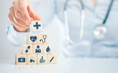 Picture of a medical provider stacking small blocks on top of each other to make a pyramid.